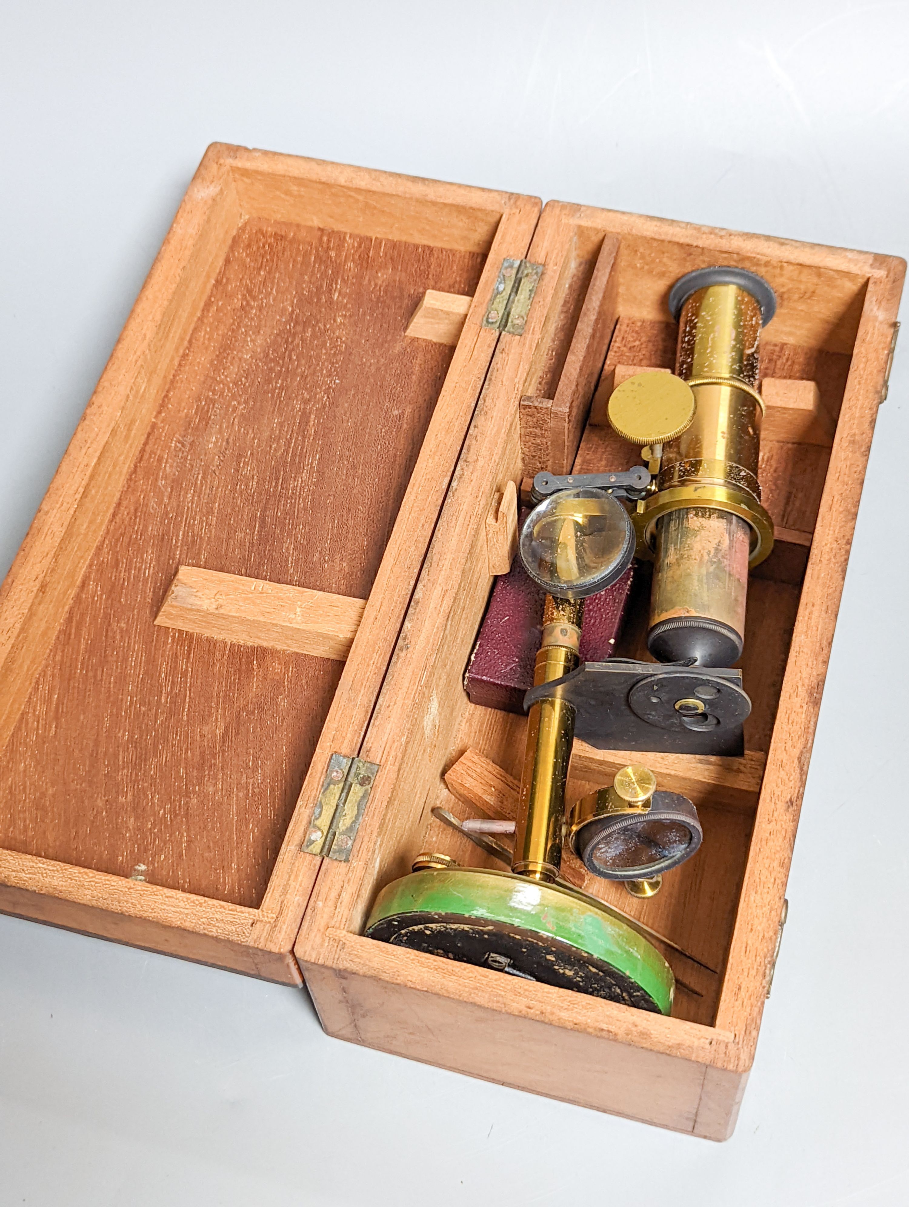 A mahogany cased brass compound microscope